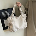 Lumina Wear Lunelle black handbag with spacious interior and versatile strap, featuring sleek design and elegant style.