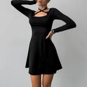 Black Lyra A-Line mini dress with square neckline from Lumina Wear, displayed on a hanger against a neutral background.