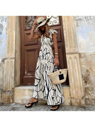 Lumina Vancouver Maddie™ elegant printed dress displayed on a hanger, showcasing its stylish design and vibrant pattern.