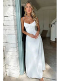 Yellow lace-up sleeveless maxi dress by Lumina Wear, perfect for wedding guests, shown on a model in a bright outdoor setting.