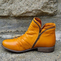 Makayla Lumina black leather ankle boots with sleek design, pointed toes, and low heel, displayed on a white background.