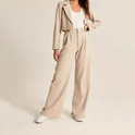 Cream high-waisted wide-leg trousers by Lumina Wear, styled on a woman, showcasing the relaxed fit and elegant design.