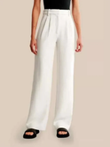 Cream high-waisted wide-leg trousers by Lumina Wear, styled for a chic look, shown on a model in XS size.