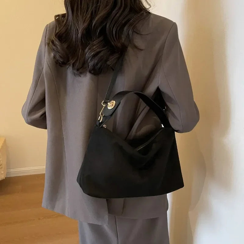 Textured Marielle Lumina minimalist shoulder bag with curved shape, coffee color, stylish handbag for everyday use.
