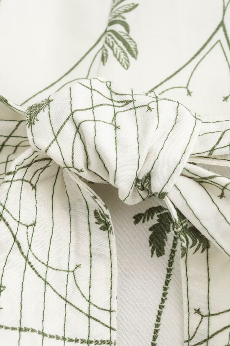 Lumina Vancouver Marin Willow wrap mini dress with V-neck in white and green, featuring a stylish and feminine design.