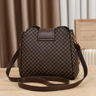 Black Marjorie quilted charm handbag with adjustable strap by Lumina Wear, featuring elegant stitching and compact design.