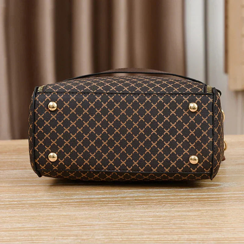 Black Marjorie Lumina Wear quilted charm handbag with adjustable strap, showcasing elegant stitching and compact design.