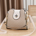 Black Marjorie quilted charm handbag with adjustable strap by Lumina Wear, featuring elegant stitching and compact design.