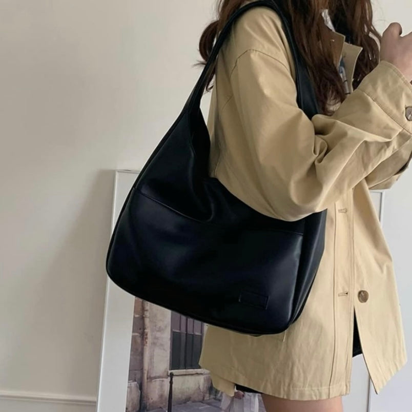 Black Lumina Maya shoulder bag made of chic vegan leather with a spacious design, perfect for stylish everyday use.