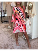 Lumina Wear Mirabella vibrant abstract print dress in coral pink, showcasing a stylish and colorful design.