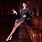 Black sequin mini dress by Lumina Vancouver, sleeveless with a fitted silhouette, perfect for evening wear.