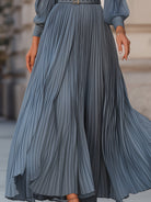 Steel blue pleated midi dress by Lumina Wear, featuring a flowy maxi design with a fitted waist and elegant pleats.