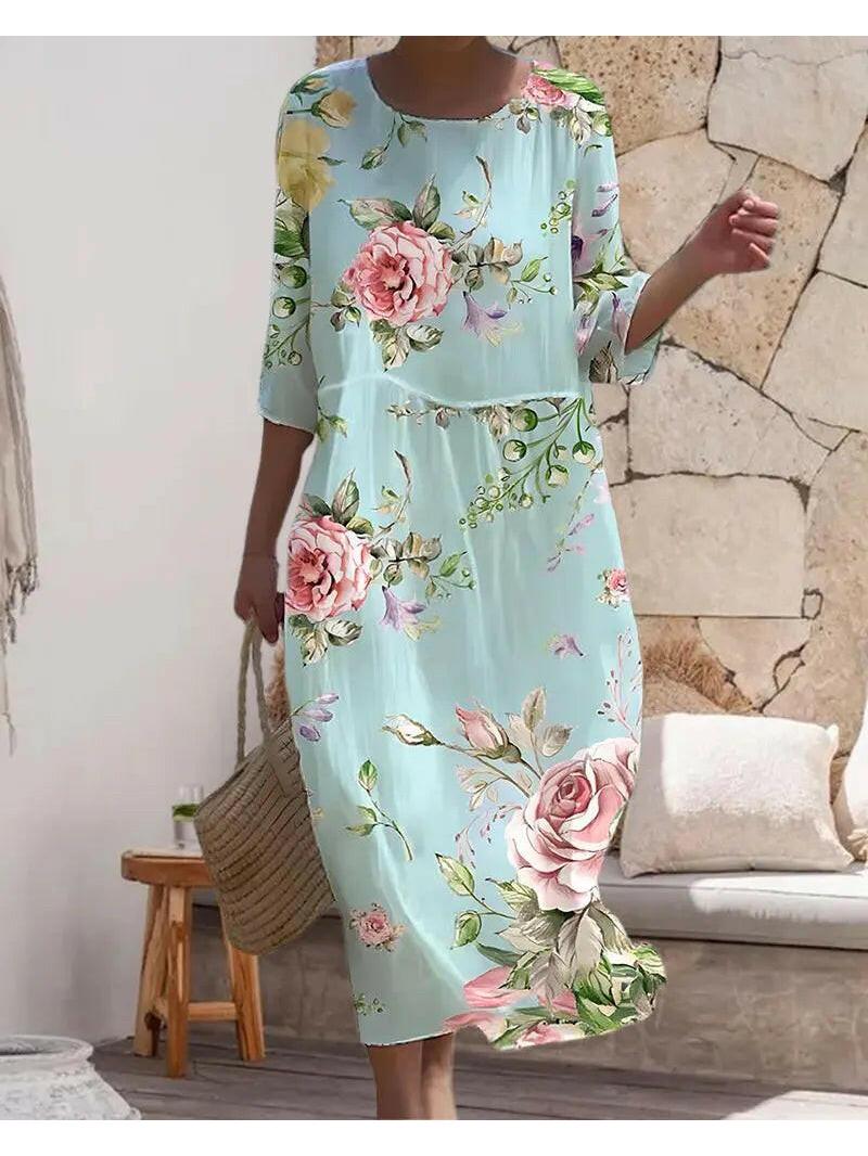 Blue Naia floral dress by Lumina Vancouver, featuring an elegant design with a stylish, feminine silhouette.