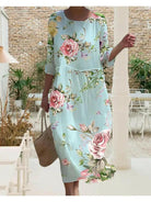 Naia elegant floral dress by Lumina Vancouver, blue color, stylish design with floral pattern, displayed on a dress form.