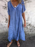 Blue NIA™ maxi dress by Lumina Vancouver, flowy and stylish for summer, displayed on a hanger against a neutral background.