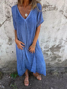 Blue NIA™ maxi dress by Lumina Vancouver, flowing chiffon fabric, elegant design, perfect for summer occasions.
