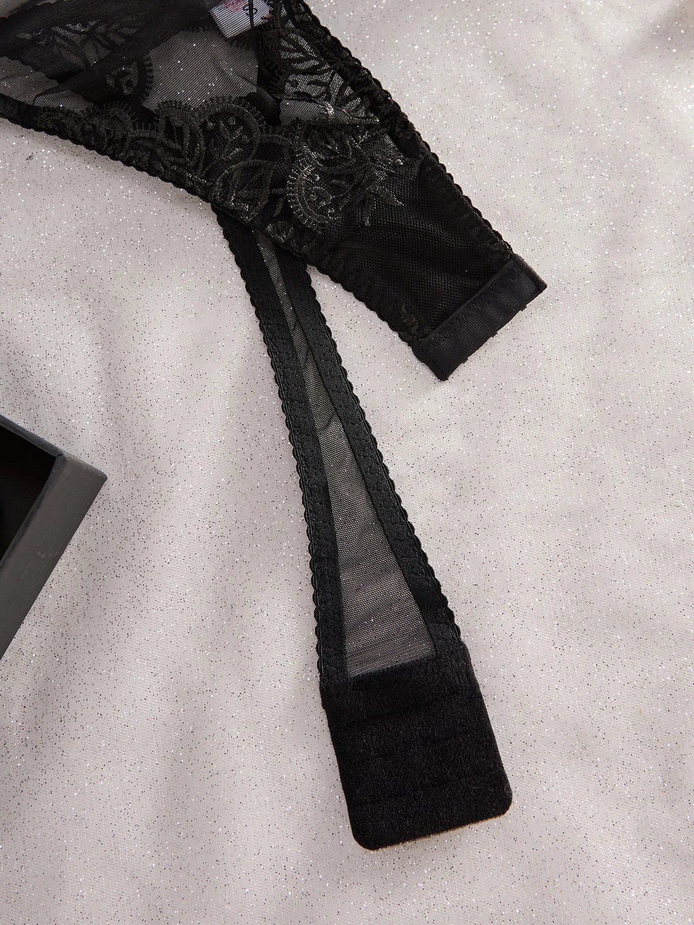 Noemi S bodysuit by Lumina Vancouver, sleek black bodysuit with fitted design and long sleeves, displayed flat.