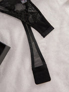 Noemi S bodysuit by Lumina Vancouver, sleek black bodysuit with fitted design and long sleeves, displayed flat.