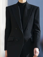 Black double-breasted peak lapel blazer by Lumina Vancouver, tailored fit with sculpted design, shown on a model.