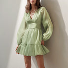 Green Sadhbh A-Line Mini Dress with V-Neck by Lumina Vancouver, showcasing a stylish fit and elegant neckline.