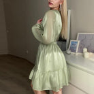 Green Sadhbh A-Line Mini Dress with V-Neck by Lumina Vancouver, showcasing a stylish and fitted silhouette with elegant details.