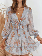 Deirdre Bella floral V-neck tie mini dress by Lumina Vancouver, pink with a fitted waist and floral pattern, perfect for summer.