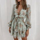 Deirdre Bella floral V-neck tie mini dress by Lumina Vancouver, pink with a fitted waist and short sleeves, perfect for summer.