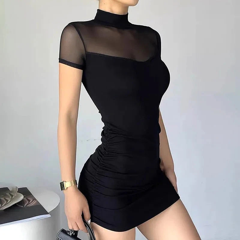 Black Berit Belle bodycon mini dress by Lumina Vancouver, fitted design with long sleeves, displayed on a hanger.