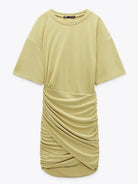 Yellow Fiadh bodycon mini dress with short sleeves by Lumina Vancouver, fitted style shown on a model.