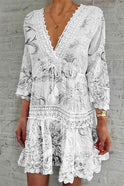 Red Nova boho mini dress with deep V-neck by Lumina Wear, featuring flowing fabric and bohemian style details.