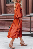 Orange Niamh Everyday Elegance midi dress by Lumina Vancouver, featuring a stylish, flowy design and sleeveless cut.