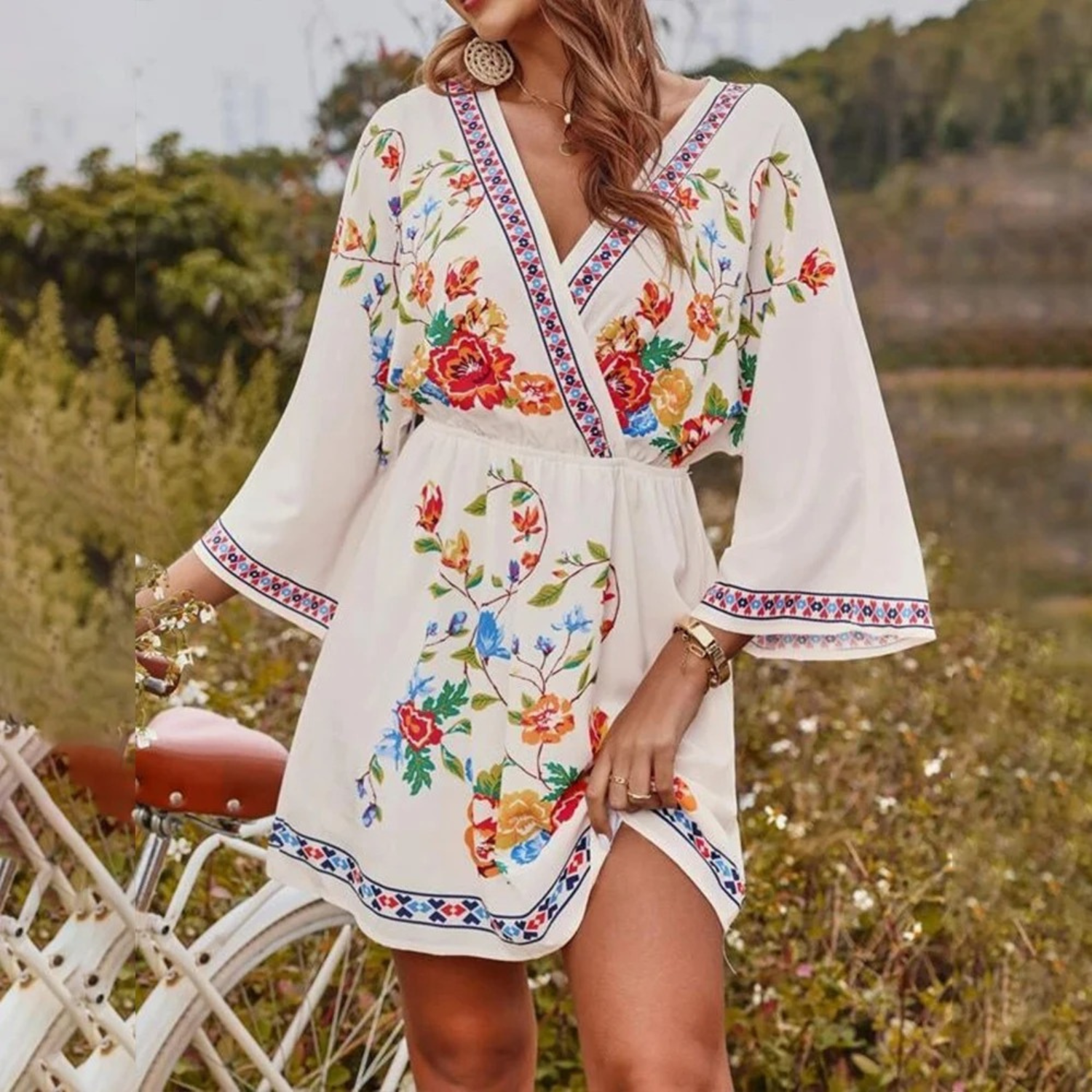 Pink and red floral print Lumina Wear Grainne V-neck mini dress, sleeveless with a fitted waist and flowy skirt.