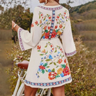 Pink and red floral print V-neck mini dress by Lumina Vancouver, featuring a fitted silhouette and lightweight fabric.