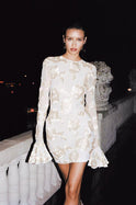 Lumina Wear Lorelei Mini Dress with open back, long sleeves, beige color, featuring a stylish, fitted silhouette.
