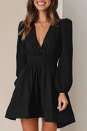 Black Nova mini dress by Lumina Wear featuring a V-neckline and puff sleeves, shown on a model.