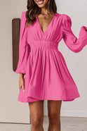 Black Nova mini dress by Lumina Wear featuring a V-neck and puff sleeves, shown on a model.