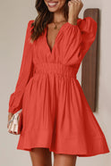 Black Lumina Wear Nova mini dress with V-neck and puff sleeves, shown on a model against a neutral background.