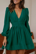 Black Nova mini dress by Lumina Wear with V-neck and puff sleeves, displayed on a hanger against a neutral background.
