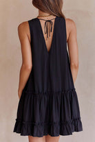 Black Lumina Vancouver Emer sleeveless ruffle mini dress with deep V-neck, styled for a chic, fashionable look.