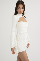 Ivory Fionnuala satin mini dress with twisted neckline, by Lumina Vancouver, shown on a model with a sleek, stylish look.