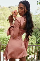 Fionnuala satin mini dress with twisted neckline by Lumina Vancouver, ivory color, shown on a model.