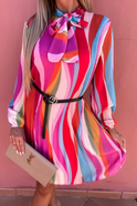 Red Lumina Wear Nova pleated mini dress with striped design, shown on a model, featuring a stylish, fitted silhouette.