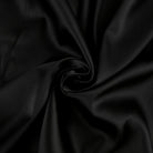 Black Vesna satin mini dress by Lumina Vancouver, form-fitting style, shown on a model with a sleek, elegant look.