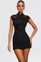 Black Lumina Vancouver Temperance satin mini dress with lace embroidery, featuring a fitted silhouette and elegant design.