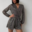 Lavinia sequin wrap dress by Lumina Vancouver featuring a deep V-neck and silver sequins, styled as a mini dress.