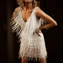 Lumina Wear Nova sleeveless mini dress with fringe detailing in white, showcased on a model.