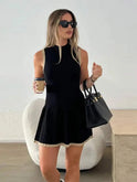 Black Nova sleeveless pleated mini dress by Lumina Wear, showcasing its stylish design and lightweight fabric.