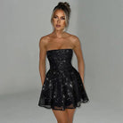 Red strapless mini dress with A-line silhouette and tulle fabric by Lumina Vancouver, shown on a model.