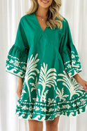 Green Nova V-neck A-line mini dress with boho print from Lumina Wear, shown on a model with flowing fabric and relaxed fit.