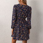Bronwyn floral print V-neck mini dress by Lumina Vancouver, shown in XS size with a vibrant floral pattern.